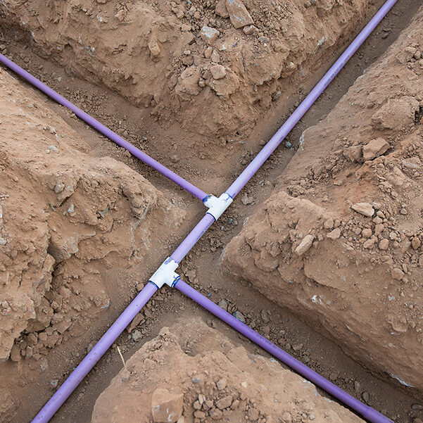 Irrigation pipe in dirt trenches for sprinkler system